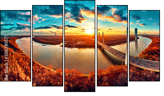 Beautiful panoramic aerial drone view to cable-stayed Siekierkowski Bridge over the Vistula river and Warsaw City skyscrapers, Poland in gold red autumn colors in November evening at sunset - Obraz pięcioczęściowy, Pentaptyk